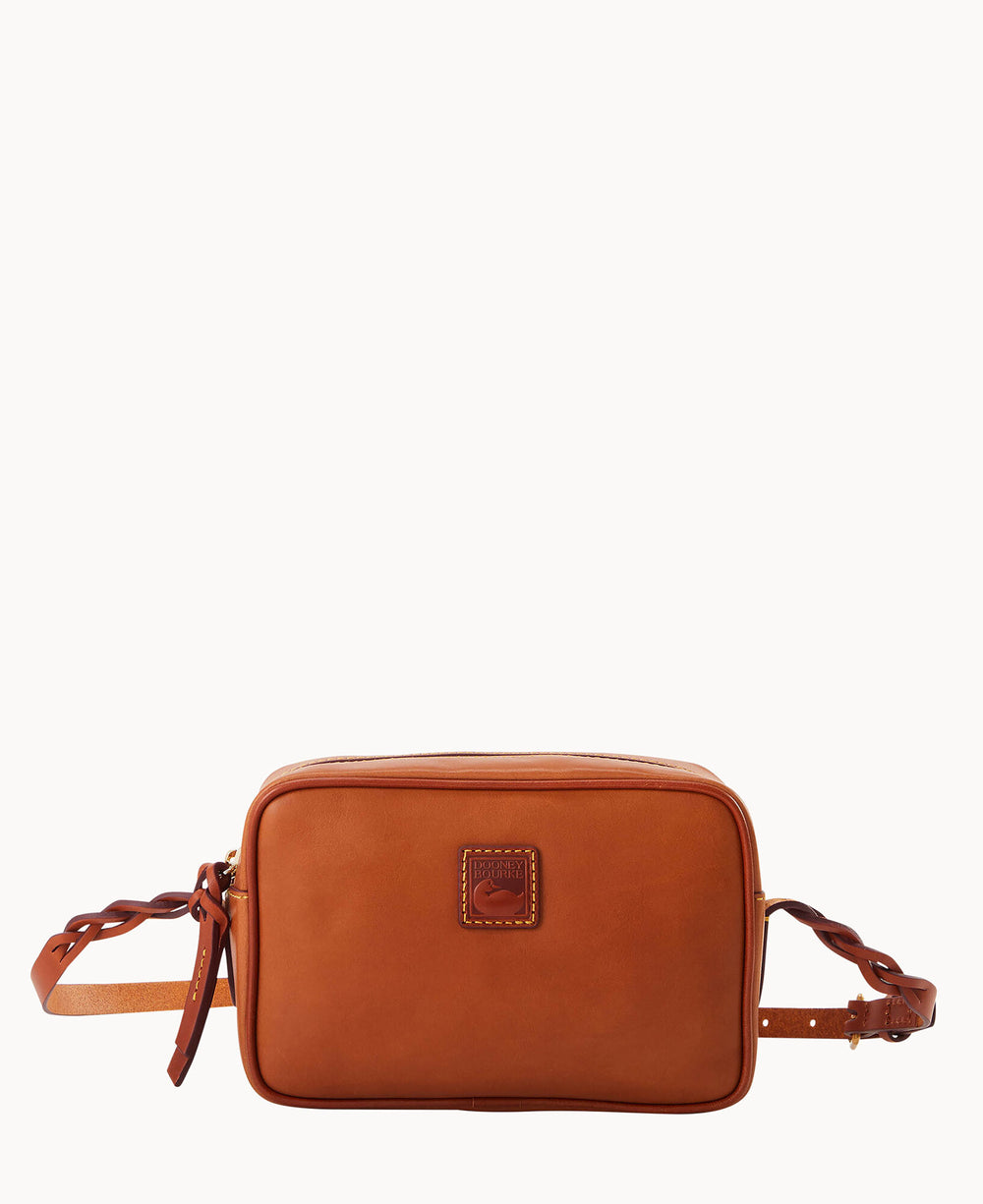 A rectangular, brown leather crossbody bag with a stitched logo patch on the front and adjustable strap featuring knotted details, displayed against a plain white background.