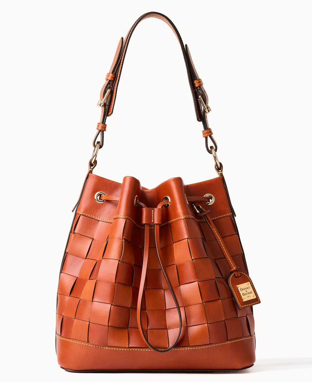 A brown woven leather bucket bag with a drawstring closure, gold-tone hardware, a top handle, and a small leather tag attached.