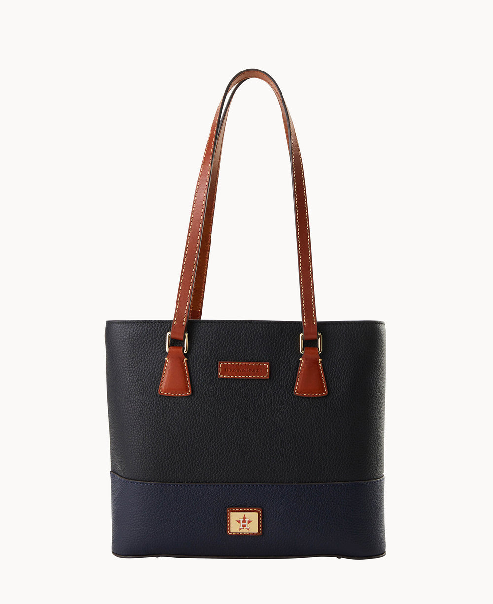 A black and navy blue leather tote bag with brown double shoulder straps and gold hardware, featuring a small logo patch on the front lower section.
