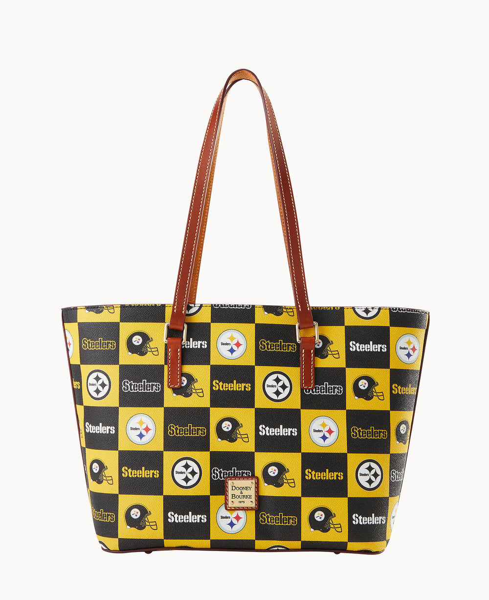 A tote bag with brown handles featuring a yellow, black, and white checkered pattern with Pittsburgh Steelers logos, football helmets, and the word Steelers throughout.