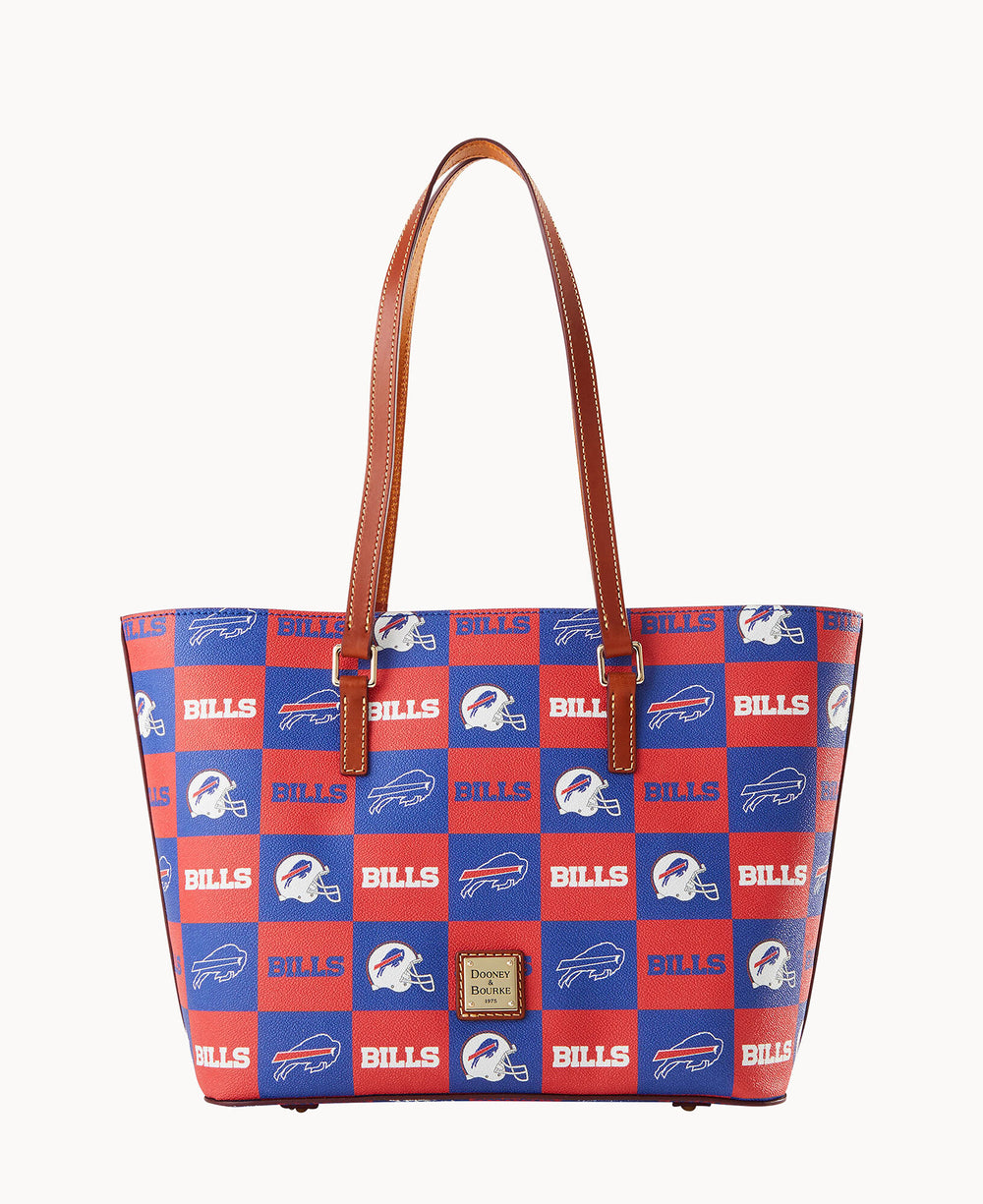 A tote bag with brown handles featuring a red and blue checkerboard pattern with BILLS text and white buffalo logos, representing the Buffalo Bills football team.