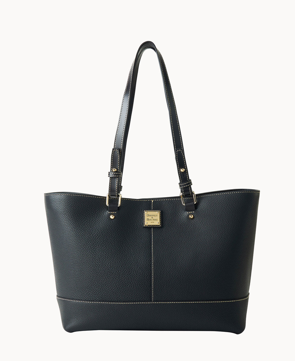 A black leather tote bag with double shoulder straps, gold-tone hardware, and a small rectangular gold logo plate on the front. The bag has subtle stitching details and a structured, spacious design.
