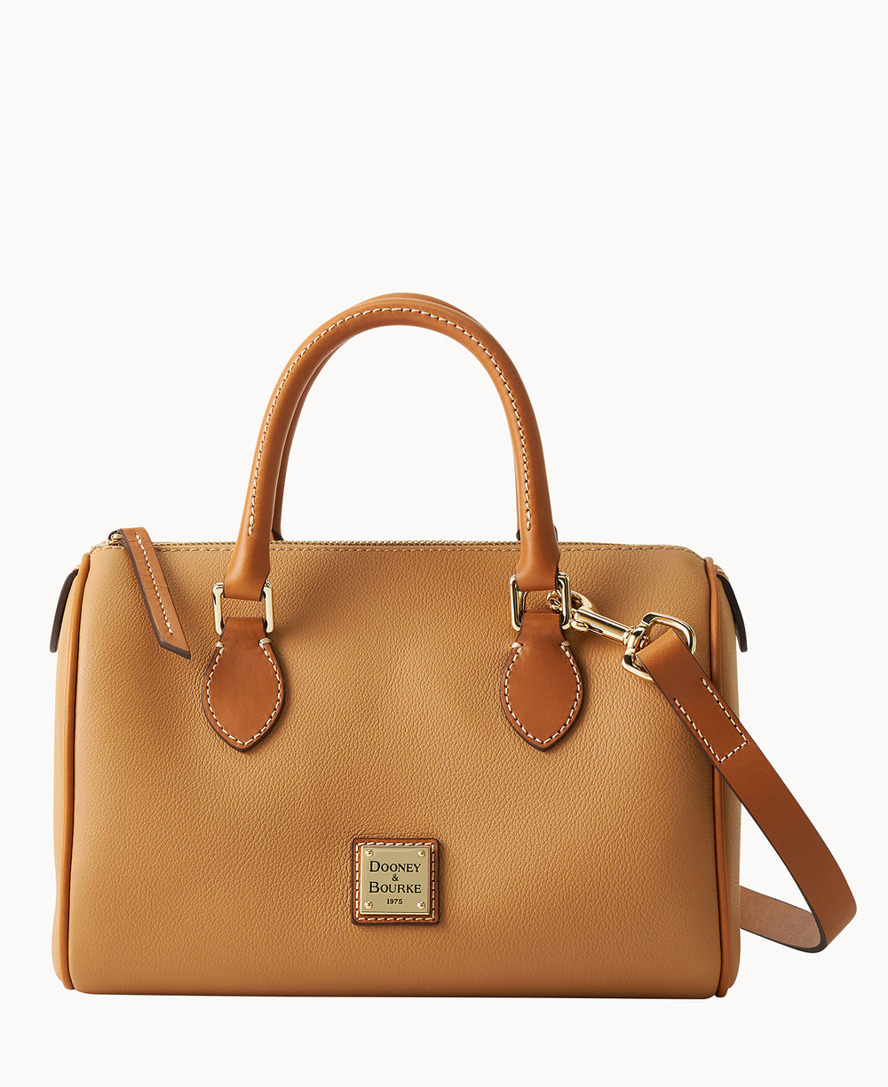 Tan leather satchel handbag with double handles, gold hardware, a detachable shoulder strap, and a small Dooney & Bourke logo patch on the front. The bag is displayed against a plain white background.