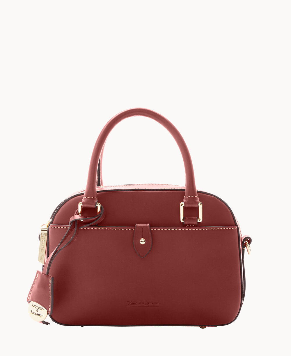 A burgundy leather handbag with two handles, gold-tone hardware, a zipper closure, and a branded hanging tag. The bag has a structured, rounded shape and minimal design.