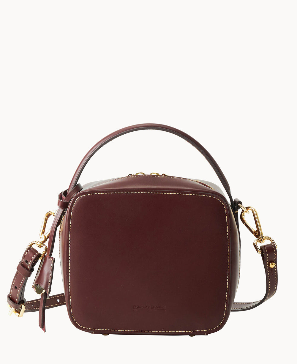 A rectangular maroon leather crossbody bag with gold hardware, a top handle, and an adjustable shoulder strap, set against a plain white background.