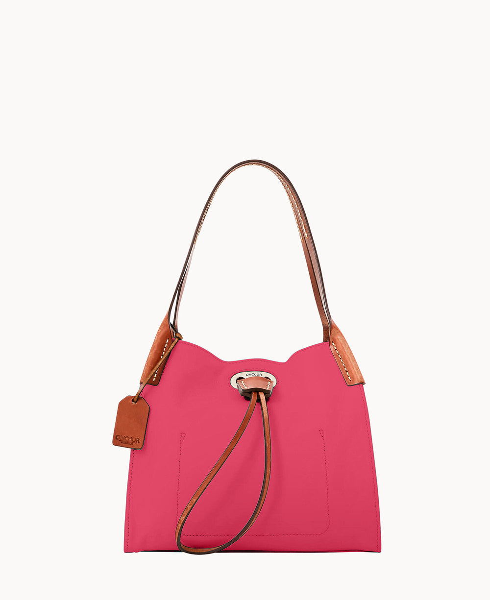 A pink shoulder bag with brown leather handles and accents, featuring a front drawstring detail and a leather tag hanging from one handle, photographed against a white background.