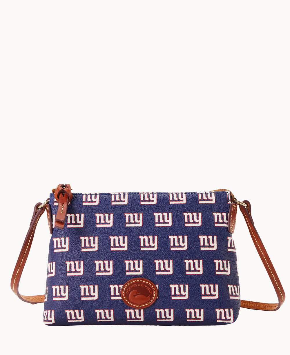A blue crossbody bag with a brown strap, featuring a repeating white and red ny logo pattern associated with the New York Giants football team and a leather logo patch on the front.