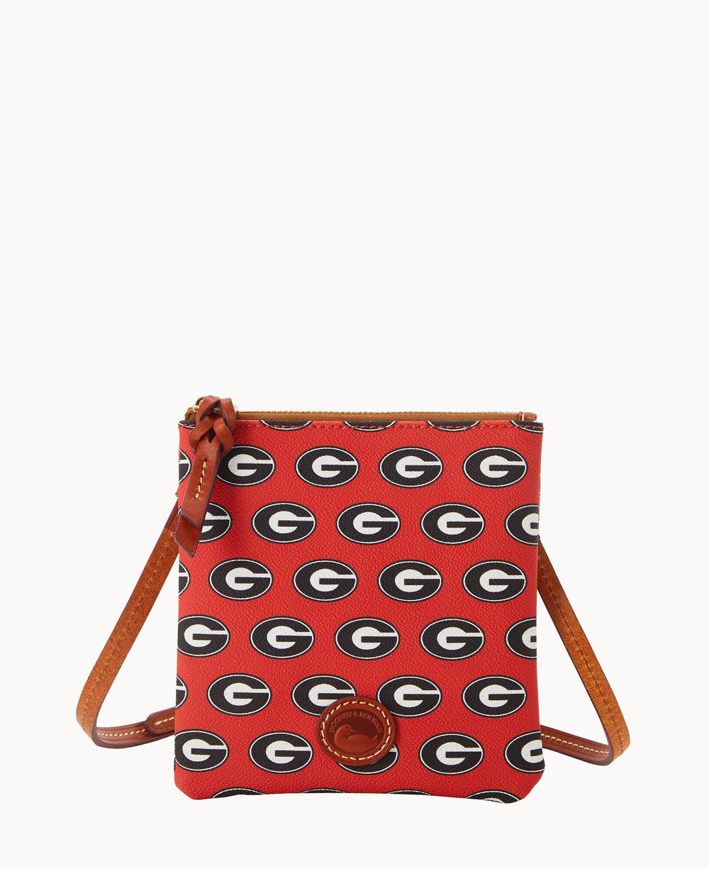 A small red crossbody bag with brown leather strap and trim, patterned with repeating black, white, and red G logos, resembling the University of Georgia emblem.
