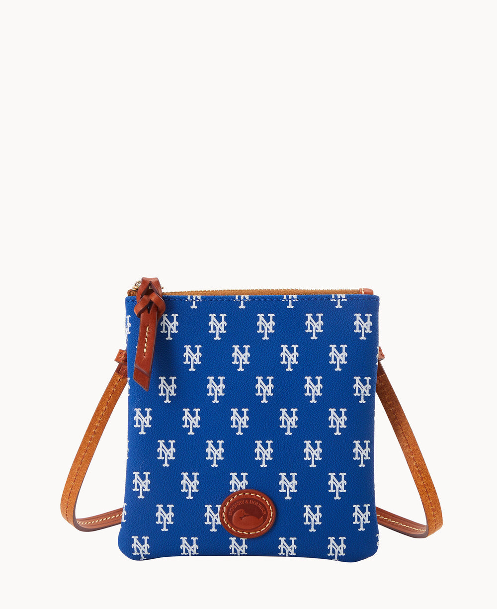 Blue crossbody bag with brown leather strap and trim, featuring an all-over white NY logo pattern; the bag has a zipper closure with a leather pull and a small oval leather patch on the lower front.