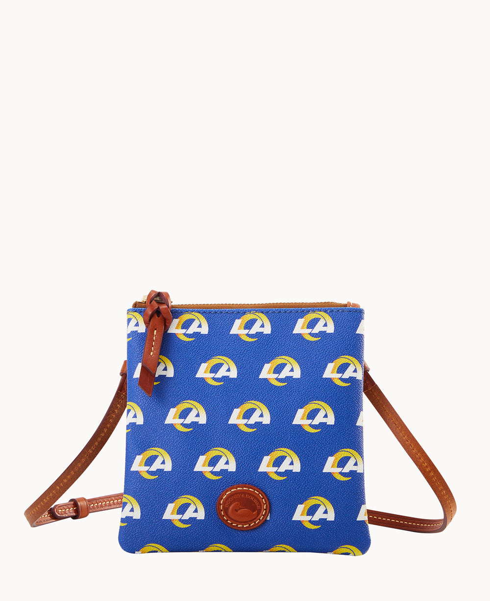 A small blue crossbody bag with brown leather strap and trim, featuring a repeating yellow and white Los Angeles Rams logo pattern and a circular leather patch on the front.