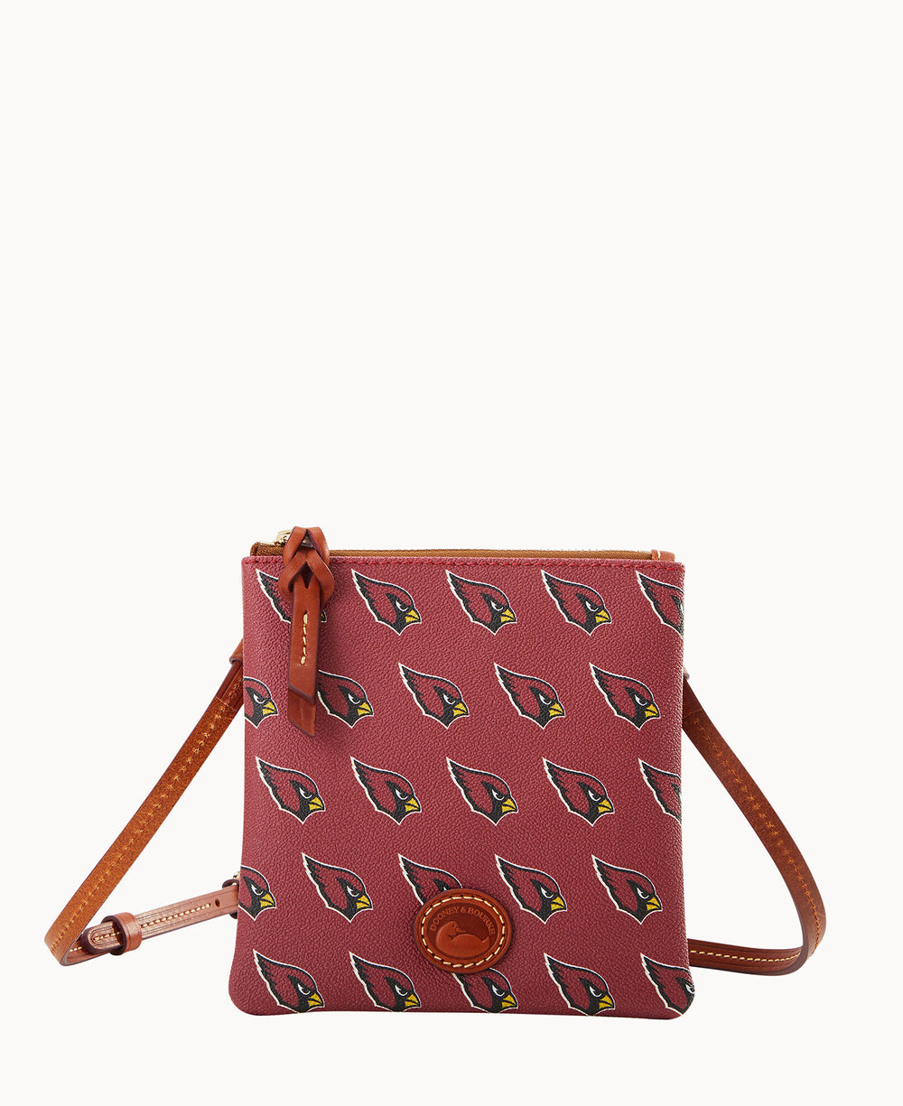 A small maroon crossbody bag with brown leather strap and zipper, featuring a repeating Arizona Cardinals logo pattern and a round leather logo patch on the front.