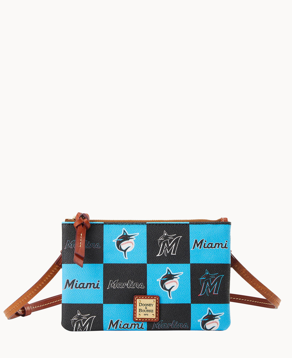 A Miami Marlins-themed Dooney & Bourke crossbody bag with a checkered pattern in blue, black, and white, featuring the teams logo and Miami text, brown leather strap, and gold brand plaque.