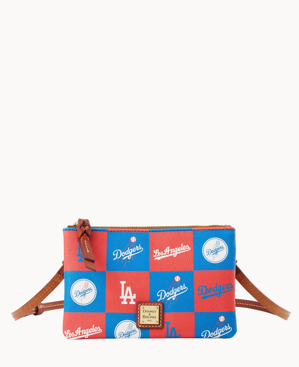 A crossbody bag with a red and blue checkered pattern featuring the Los Angeles Dodgers logo, team name, and baseball graphics. The bag has brown leather accents and a Dooney & Bourke label on the front.