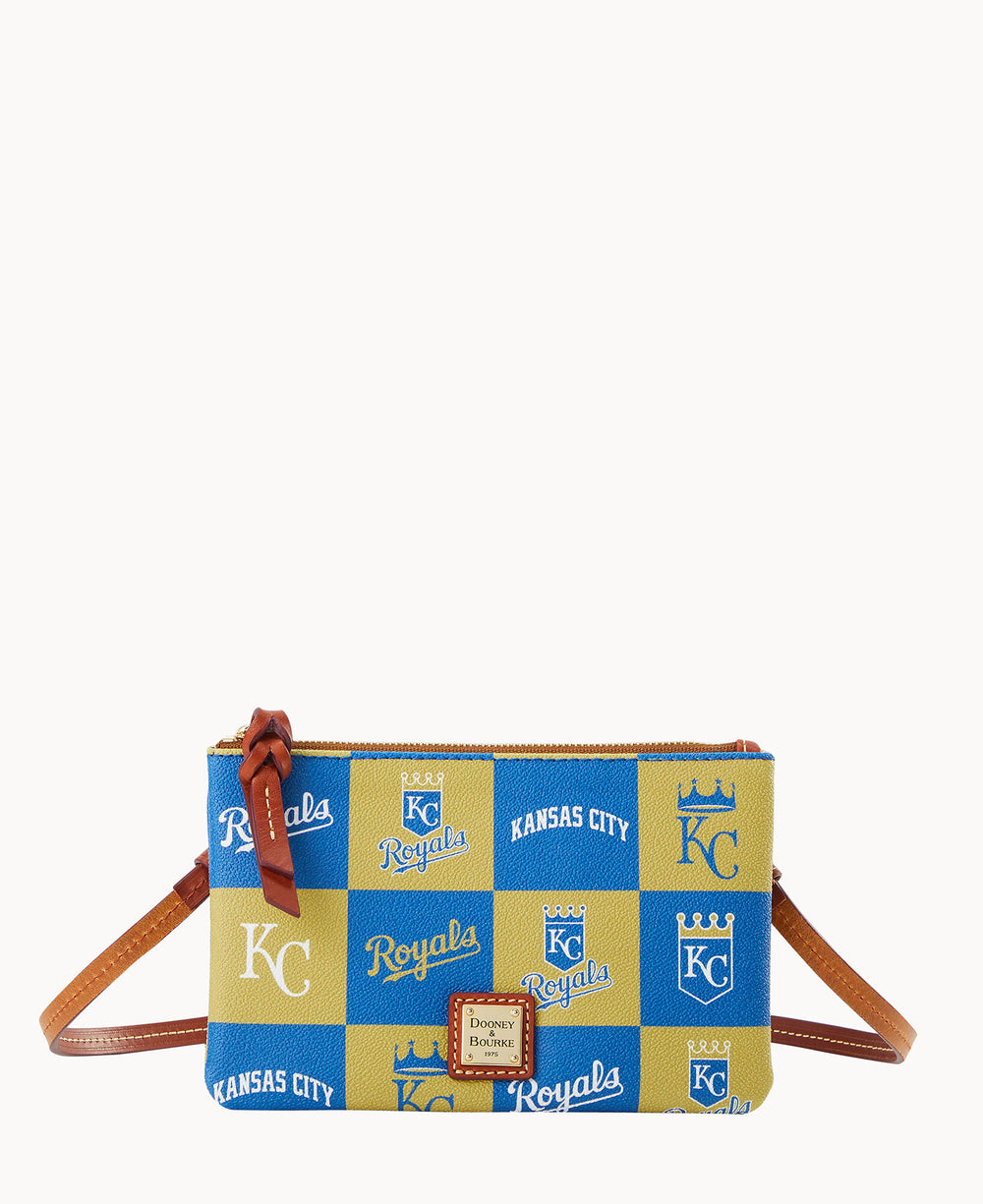 A small crossbody bag with a blue and gold checkered pattern featuring â€œKC,â€ â€œRoyals,â€ â€œKansas City,â€ crowns, and baseball logos. It has a brown strap and a leather zipper pull.
