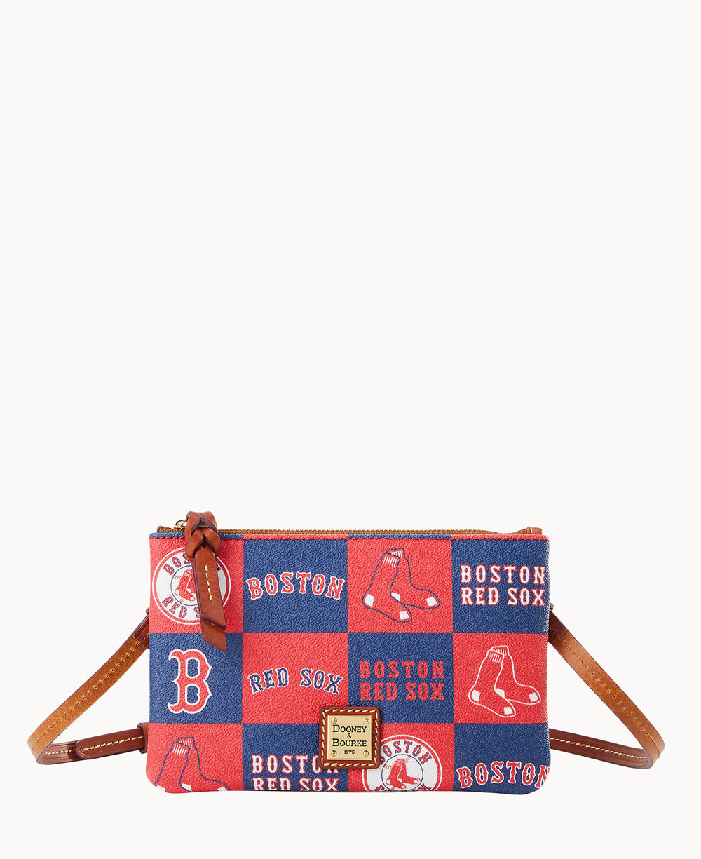 A small crossbody bag with a brown strap, featuring a red and blue Boston Red Sox patchwork design and the Dooney & Bourke logo on the front.