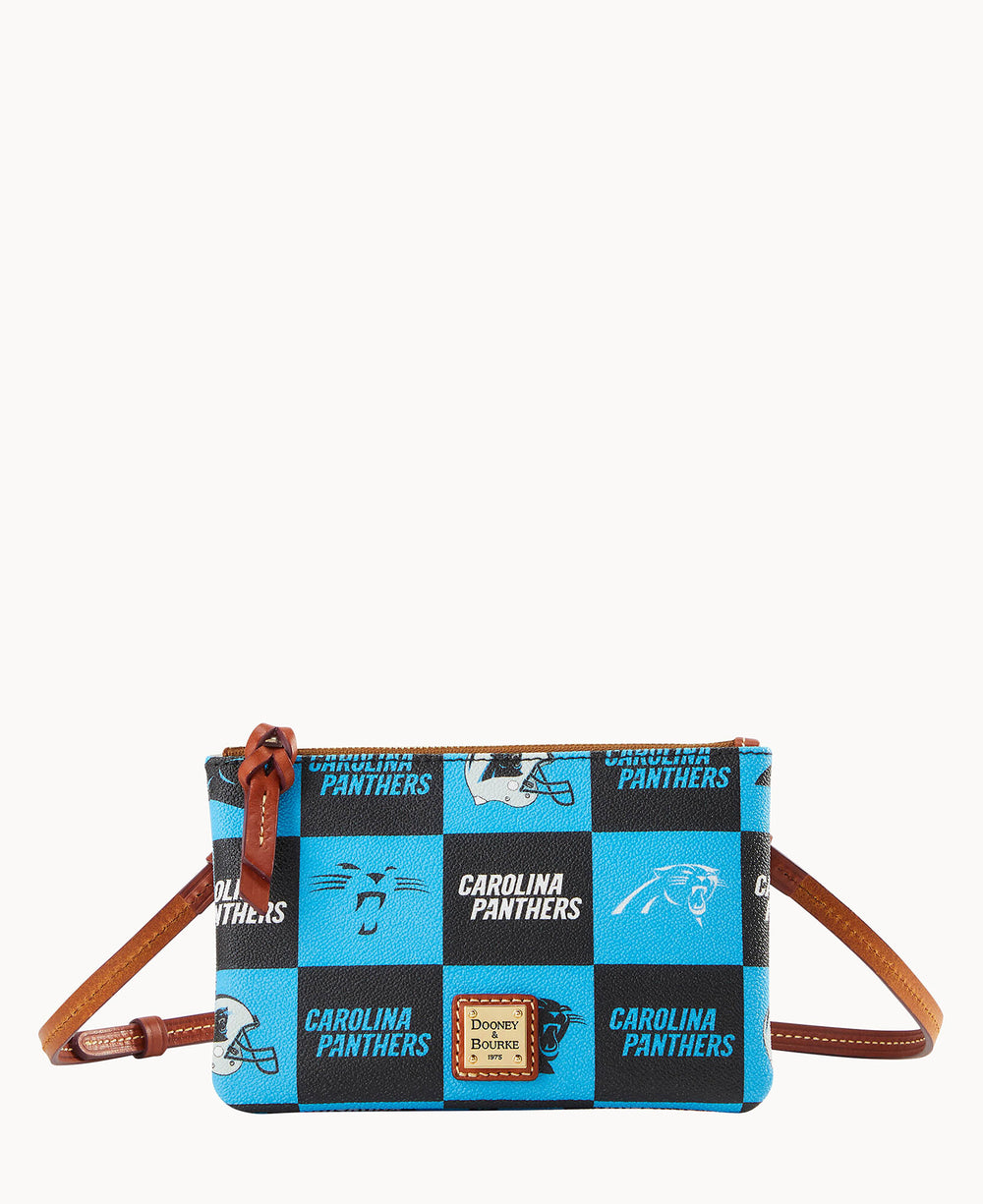 A small blue and black crossbody bag with brown leather strap, featuring the Carolina Panthers logo and text in a repeating pattern. The bag has a gold Dooney & Bourke label on the front.