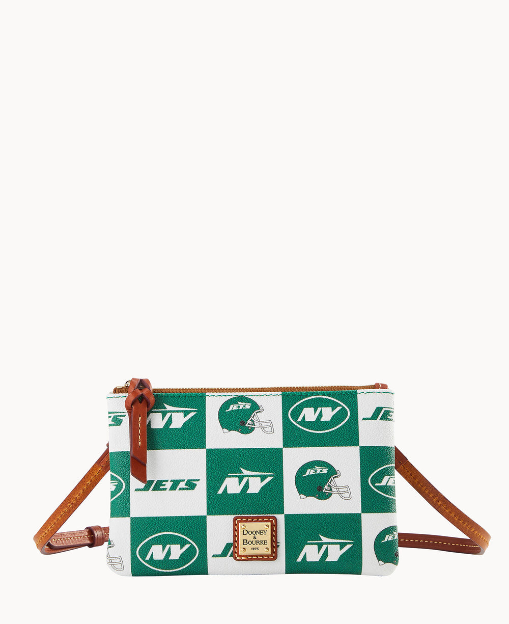 A small crossbody bag with brown leather strap and zipper, featuring a green and white checkered pattern with New York Jets logos and a Dooney & Bourke label on the front.