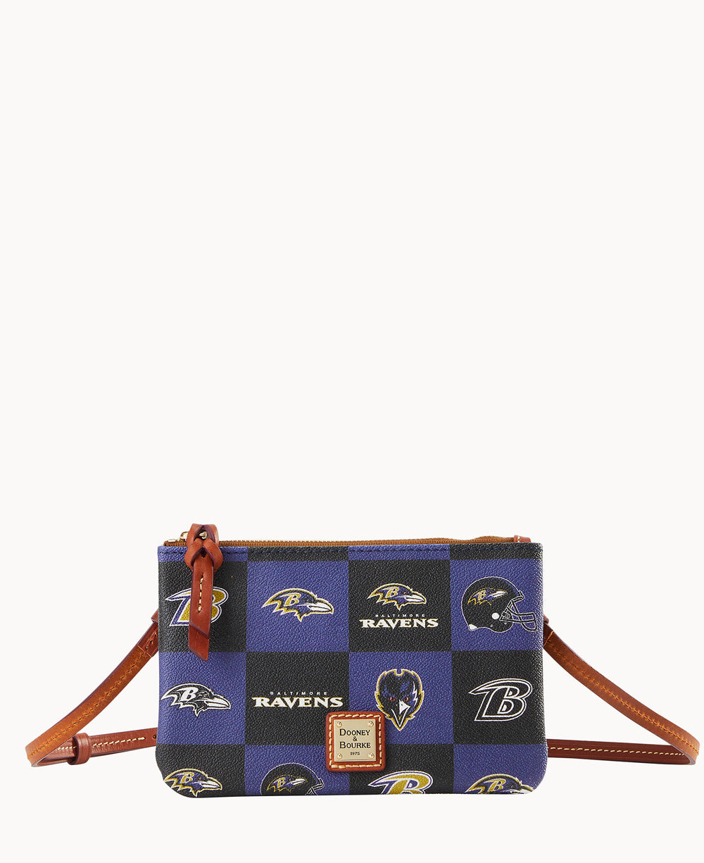 A small crossbody bag with brown leather straps, featuring a blue and black checkered pattern with various Baltimore Ravens logos and a Dooney & Bourke label on the front.