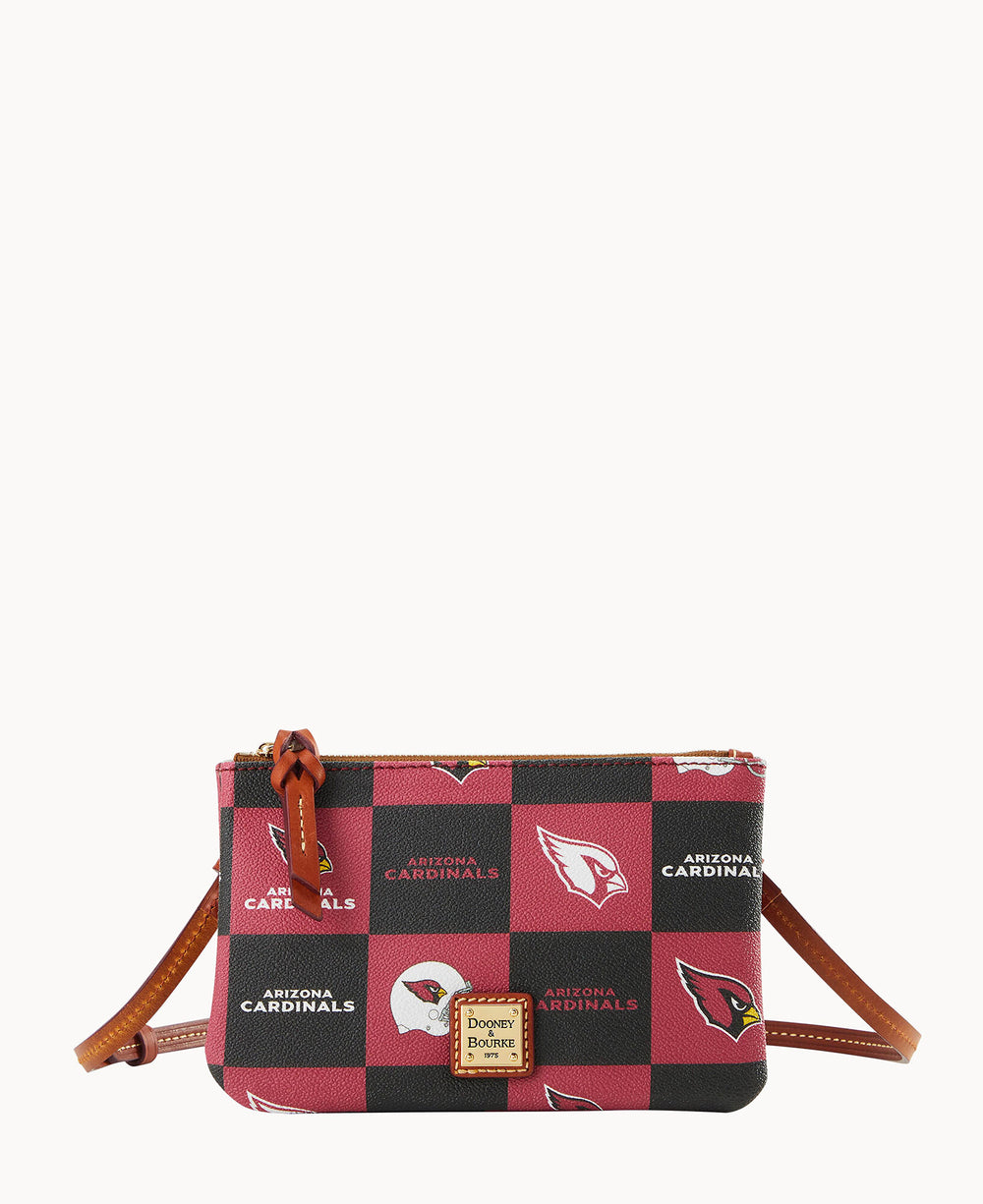 A small crossbody bag with a brown leather strap, featuring a red and black checkerboard pattern with the Arizona Cardinals logo and text, and a Dooney & Bourke label on the front.