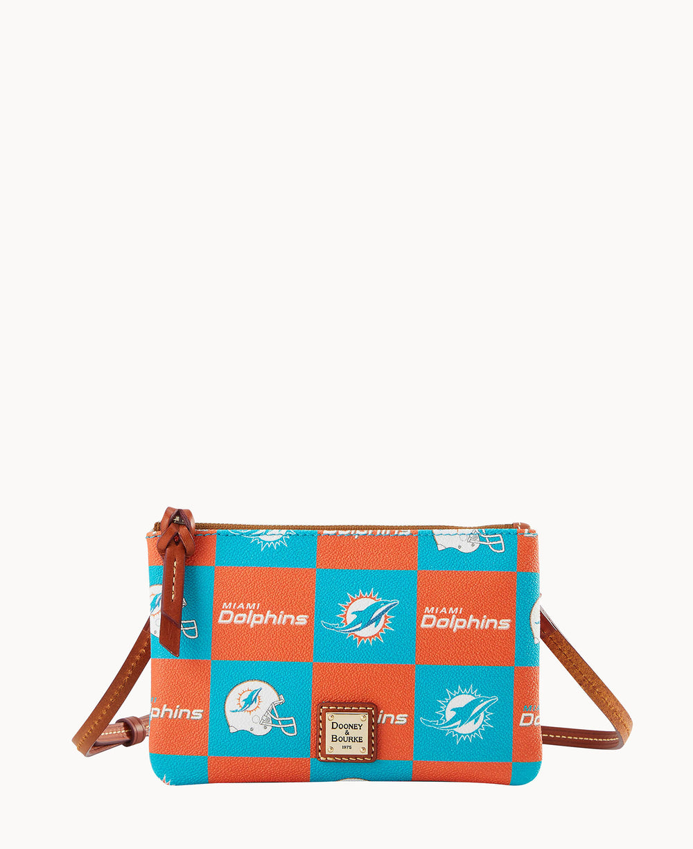 A small crossbody bag with a brown strap featuring a blue and orange checkerboard pattern, Miami Dolphins logos, and football helmets. A Dooney & Bourke label is on the front.