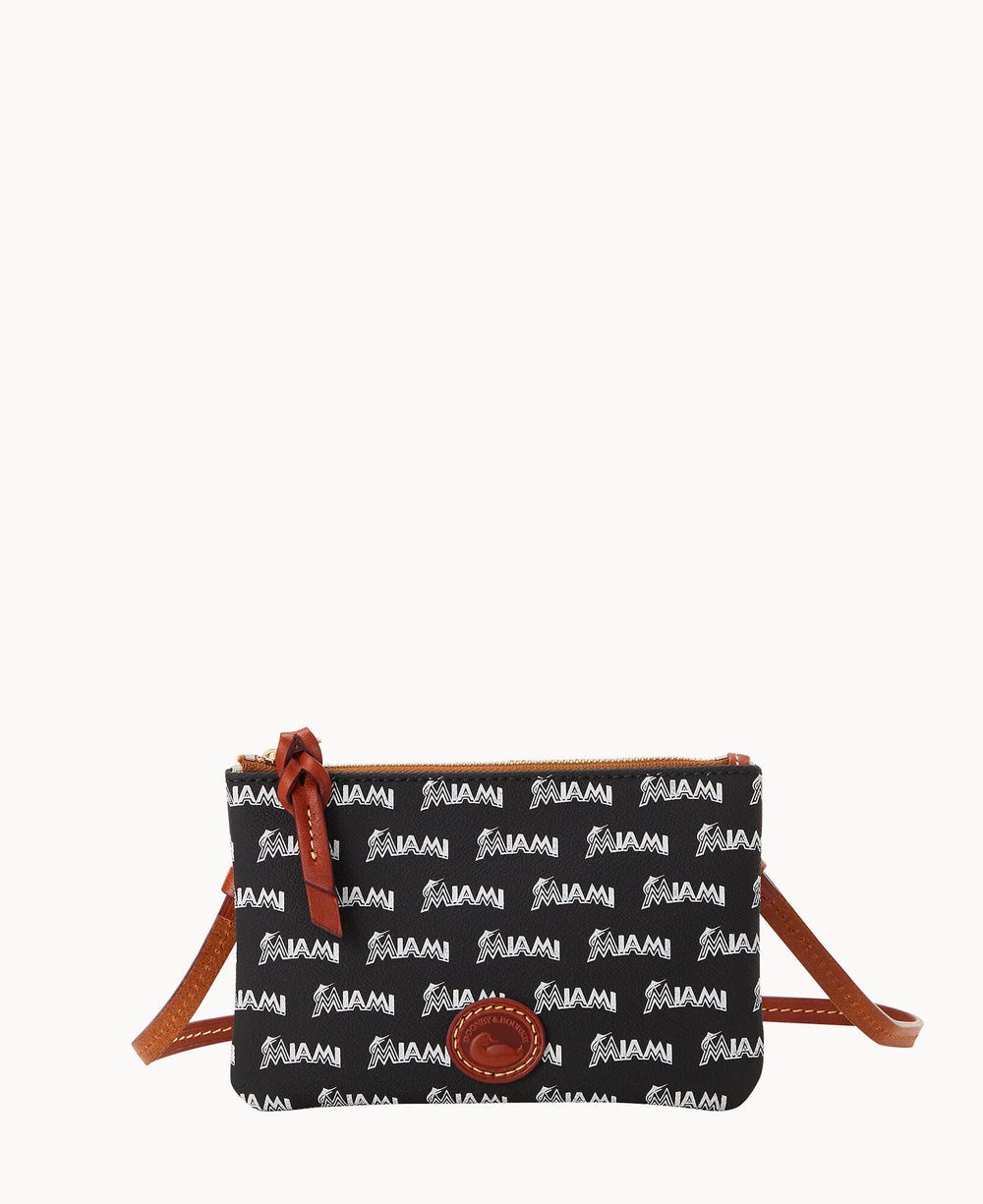 A small black crossbody bag with brown leather trim and strap, featuring a repeating white MIAMI pattern and a round brown leather logo patch on the front.