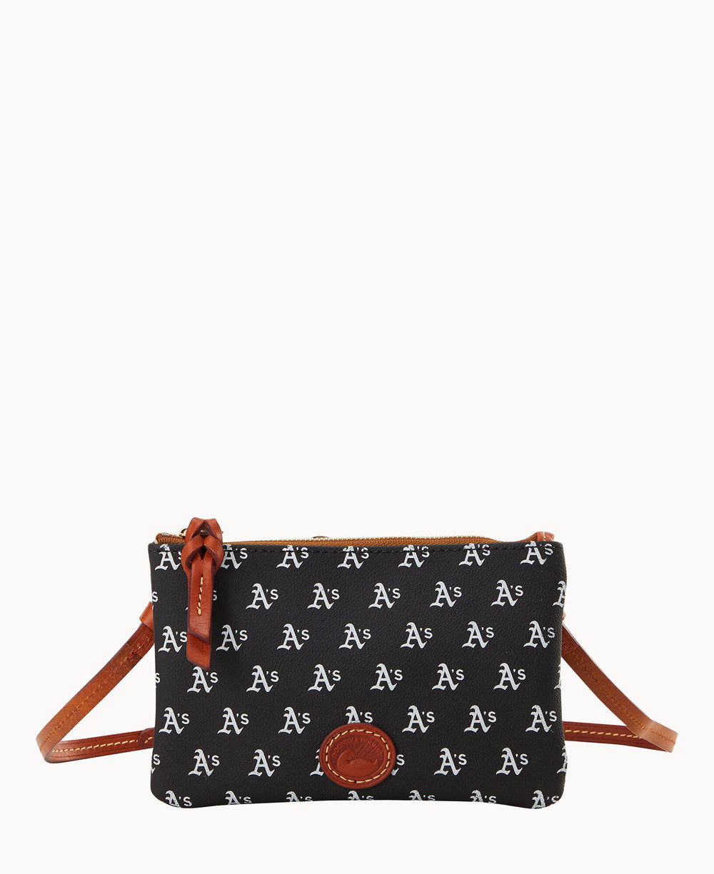 A small black crossbody bag with brown leather trim and strap, featuring a repeating white As pattern and a brown leather logo patch on the front.