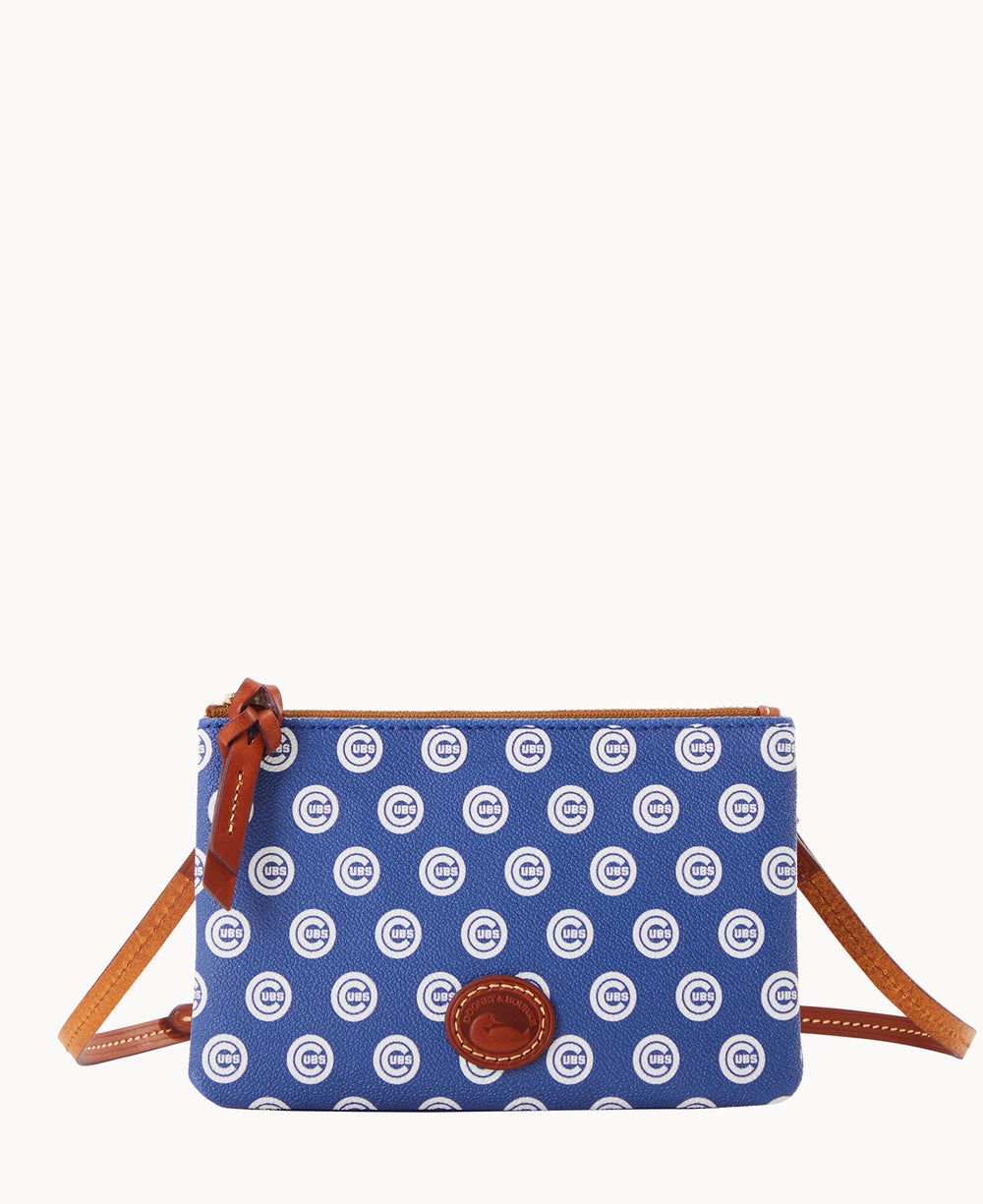 A small blue crossbody bag with a brown leather strap and accents, featuring a repeating white Chicago Cubs C logo pattern and a brown oval logo patch on the front.