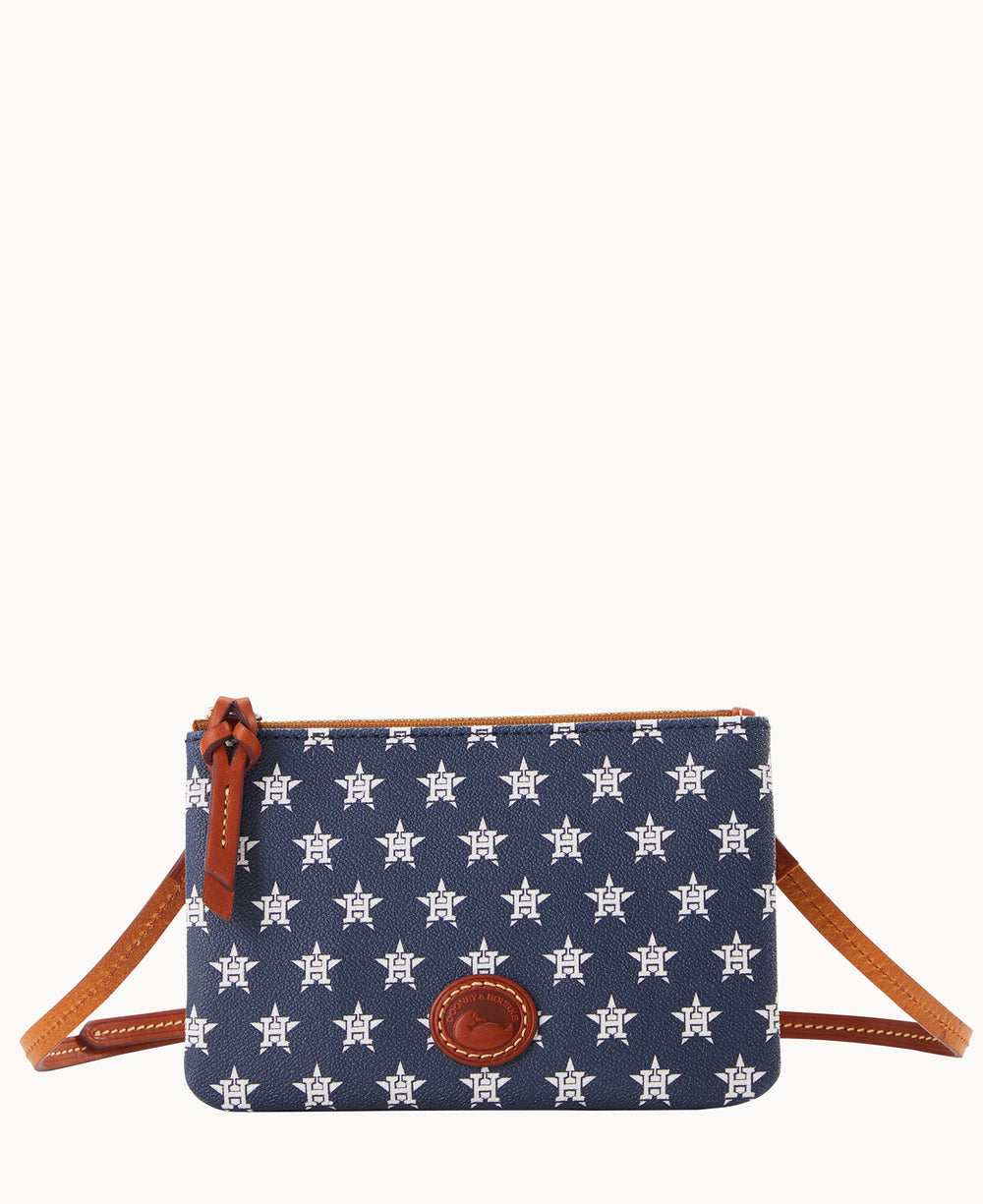 A small navy blue crossbody bag with brown leather trim, featuring a repeating white star logo pattern and a brown leather logo patch on the front. The bag has a zipper closure and an adjustable strap.