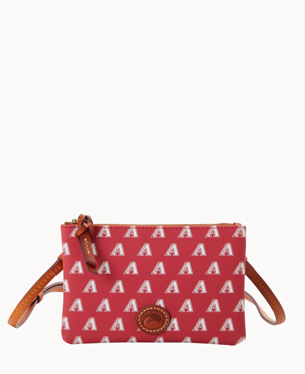 A small red crossbody bag with a repeating white letter A pattern, brown leather accents, a zipper closure, and a brown leather strap.