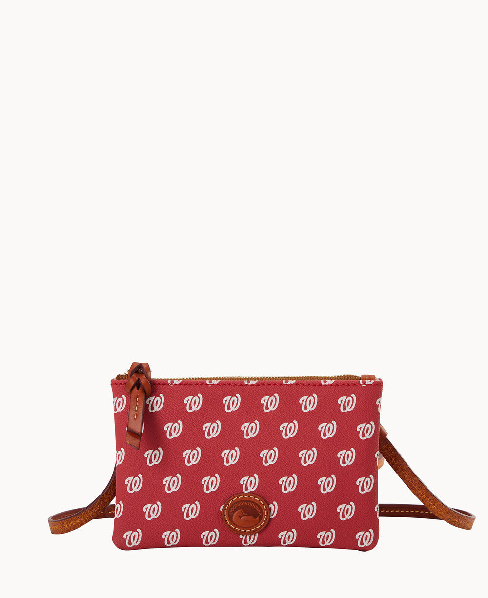 A small red crossbody purse patterned with repeating white Washington Nationals W logos, featuring brown leather accents and a zippered top.