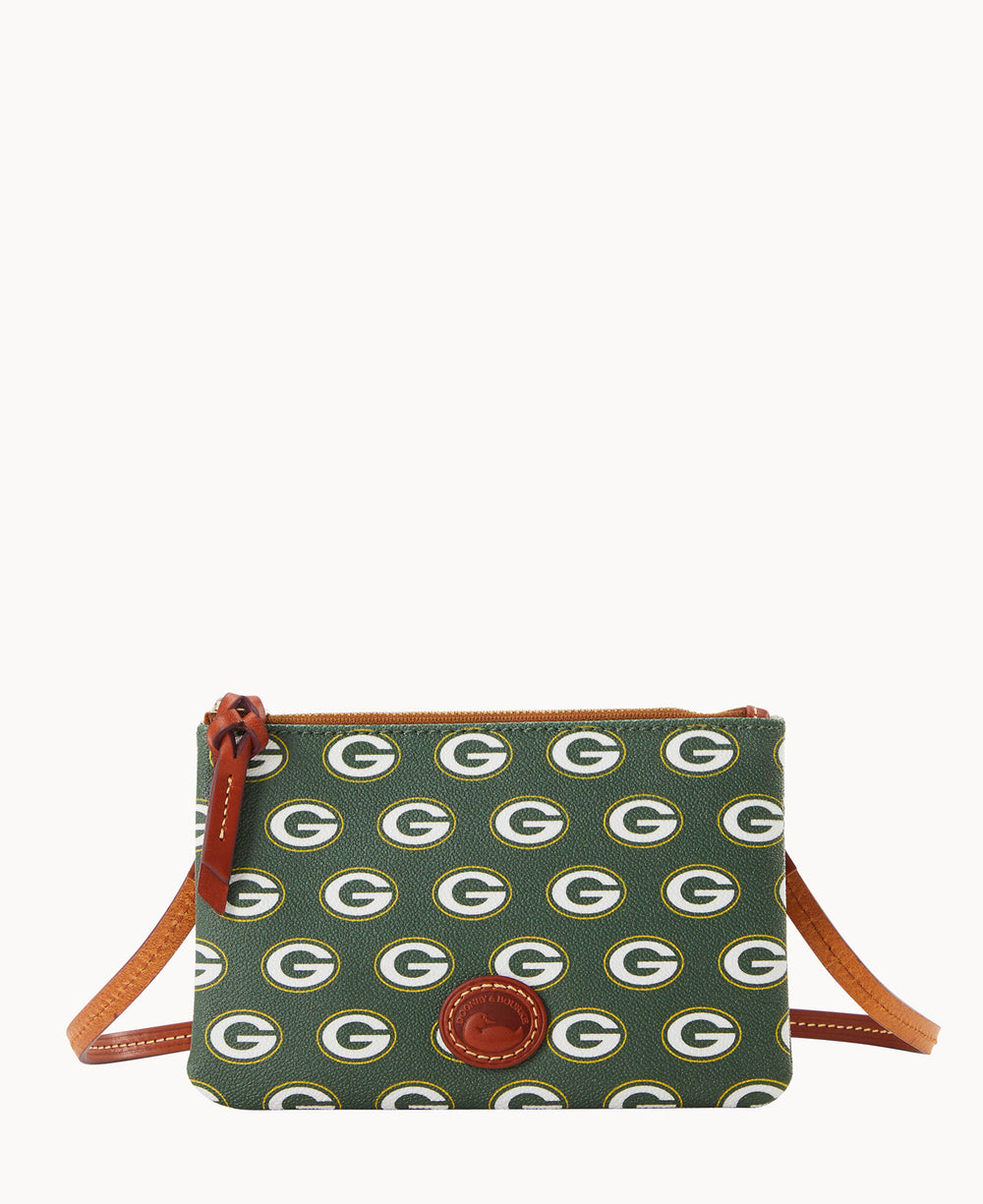 A small crossbody bag with a brown strap, featuring a repeating Green Bay Packers G logo pattern on a green background and a brown leather patch on the front.