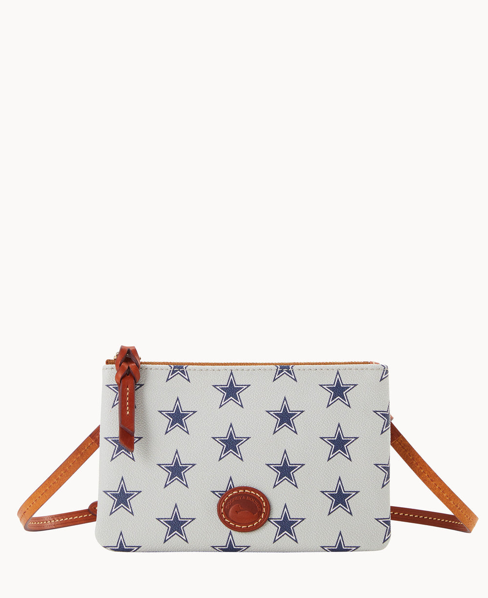 A small white crossbody bag with dark blue star patterns, brown leather zipper pull, trim, and strap, displayed against a plain white background.