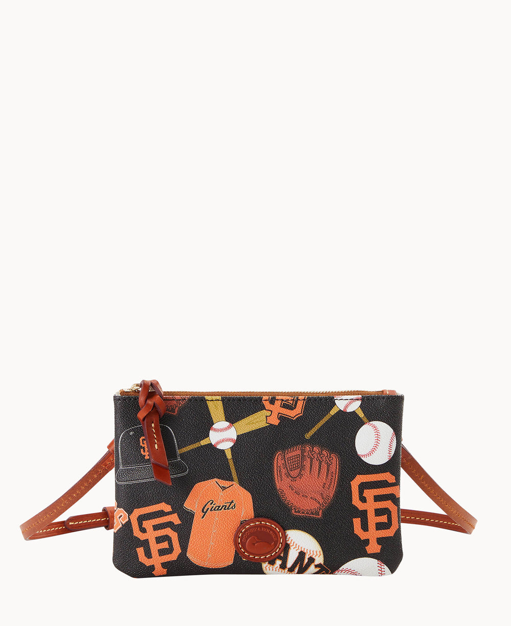 A small black crossbody bag decorated with orange San Francisco Giants logos, baseballs, a baseball glove, a jersey, and a cap, featuring brown leather accents and a zipper closure.