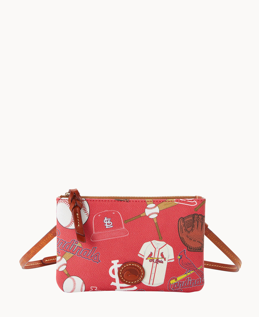 A small red crossbody bag with a brown strap, featuring a baseball-themed print with bats, balls, gloves, jerseys, and the St. Louis Cardinals logo and name in yellow script.