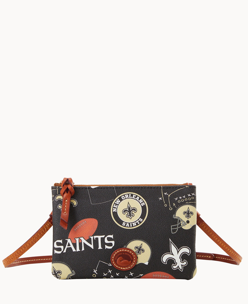 A small crossbody purse with New Orleans Saints logos, football helmets, and football graphics on a black background, featuring a brown strap and zipper pull.