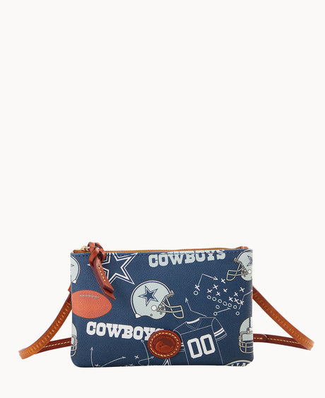A small crossbody bag with brown leather strap and zipper, featuring a blue pattern with footballs, helmets, stars, play diagrams, COWBOYS, and the number 00 in white.