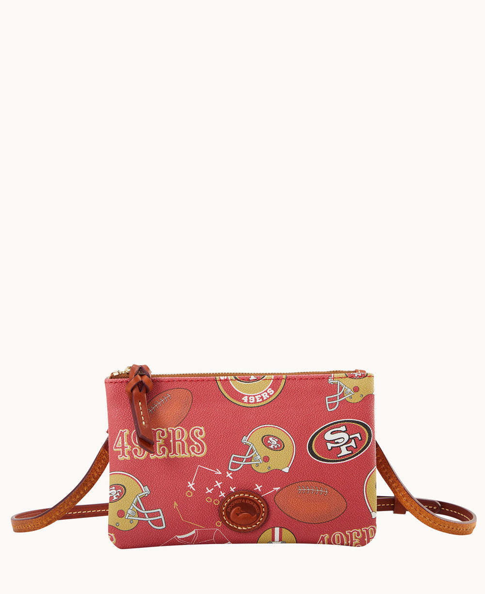 Red crossbody bag with San Francisco 49ers football team logos, helmets, and play diagrams printed on it. The bag has a brown leather strap and zipper pull.