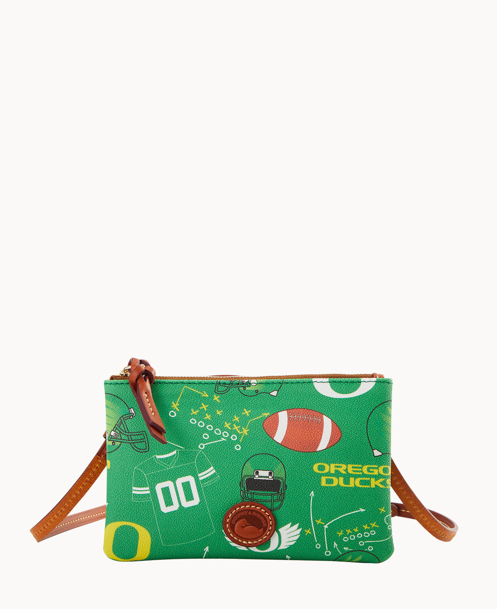 A small green crossbody purse with brown leather trim and strap, decorated with football-themed graphics, including a helmet, football, plays, and OREGON DUCKS text.