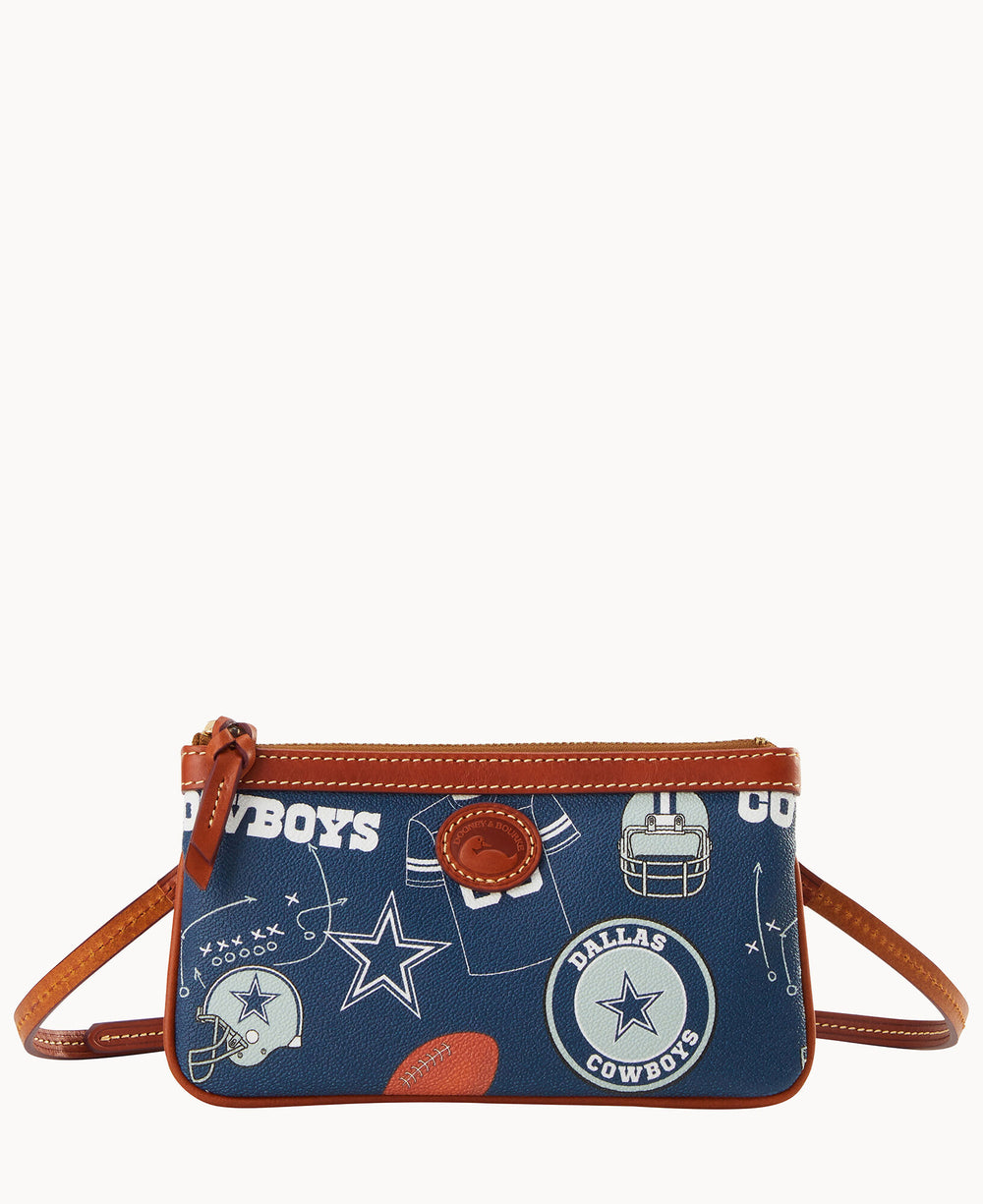 A small navy blue crossbody bag with brown trim, featuring Dallas Cowboys logos, football helmets, stars, and a football pattern throughout.