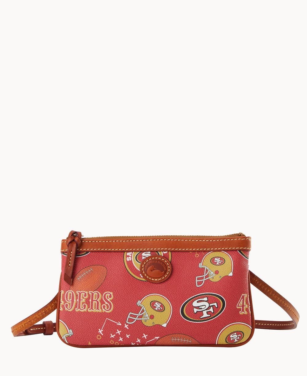A small red crossbody bag with brown trim, decorated with San Francisco 49ers logos, football helmets, and football graphics. The bag has a zipper closure and an adjustable strap.