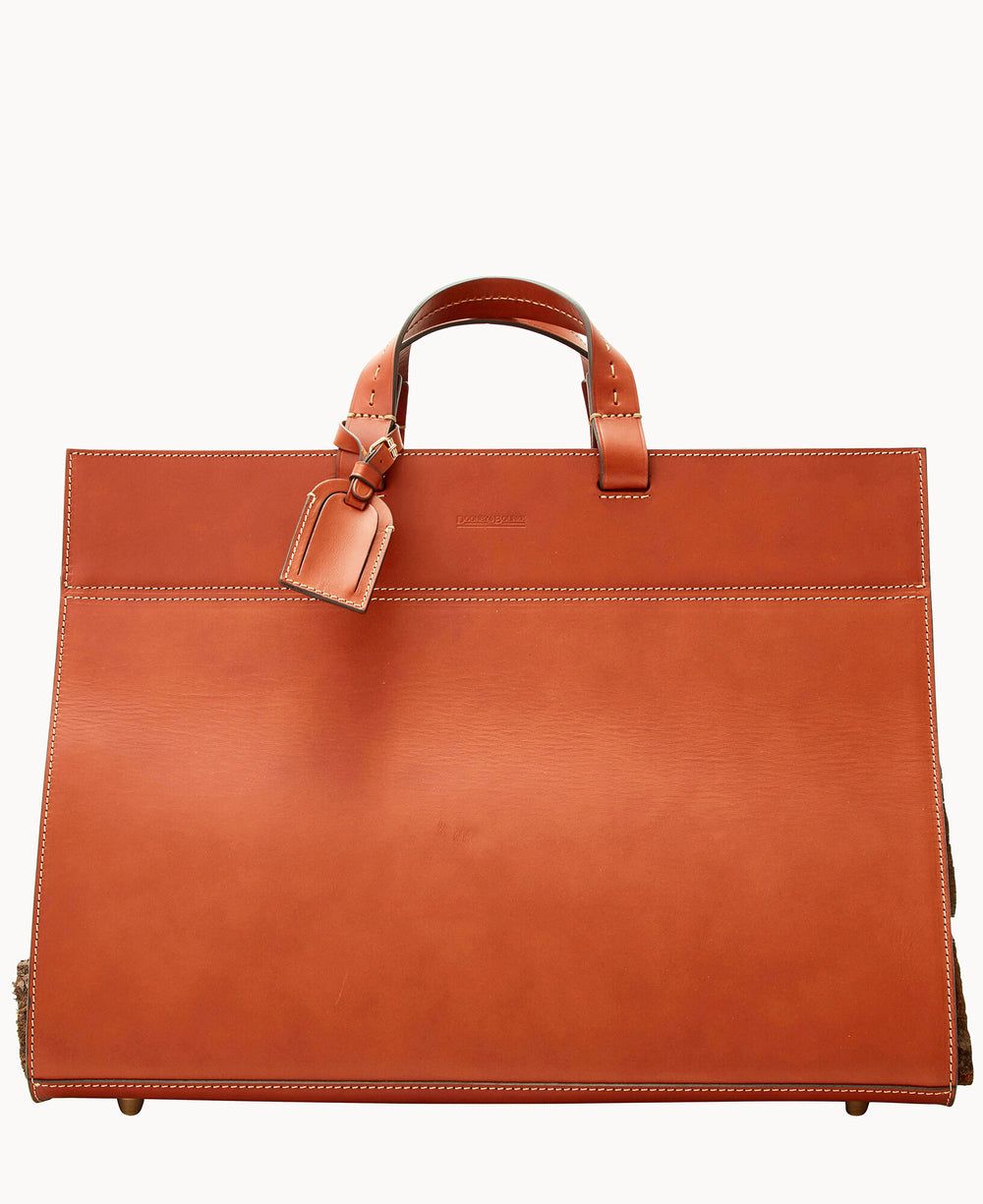 A large, structured orange-brown leather handbag with short handles, visible stitching, and a matching luggage tag attached to one handle, set against a plain white background.