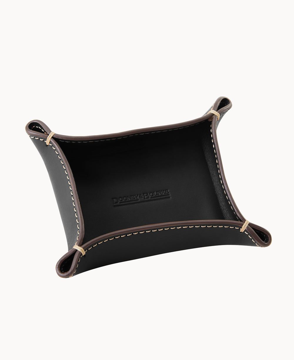 A rectangular black leather valet tray with brown edges, white stitching, and snap buttons at the corners, shown from an overhead angle on a white background.