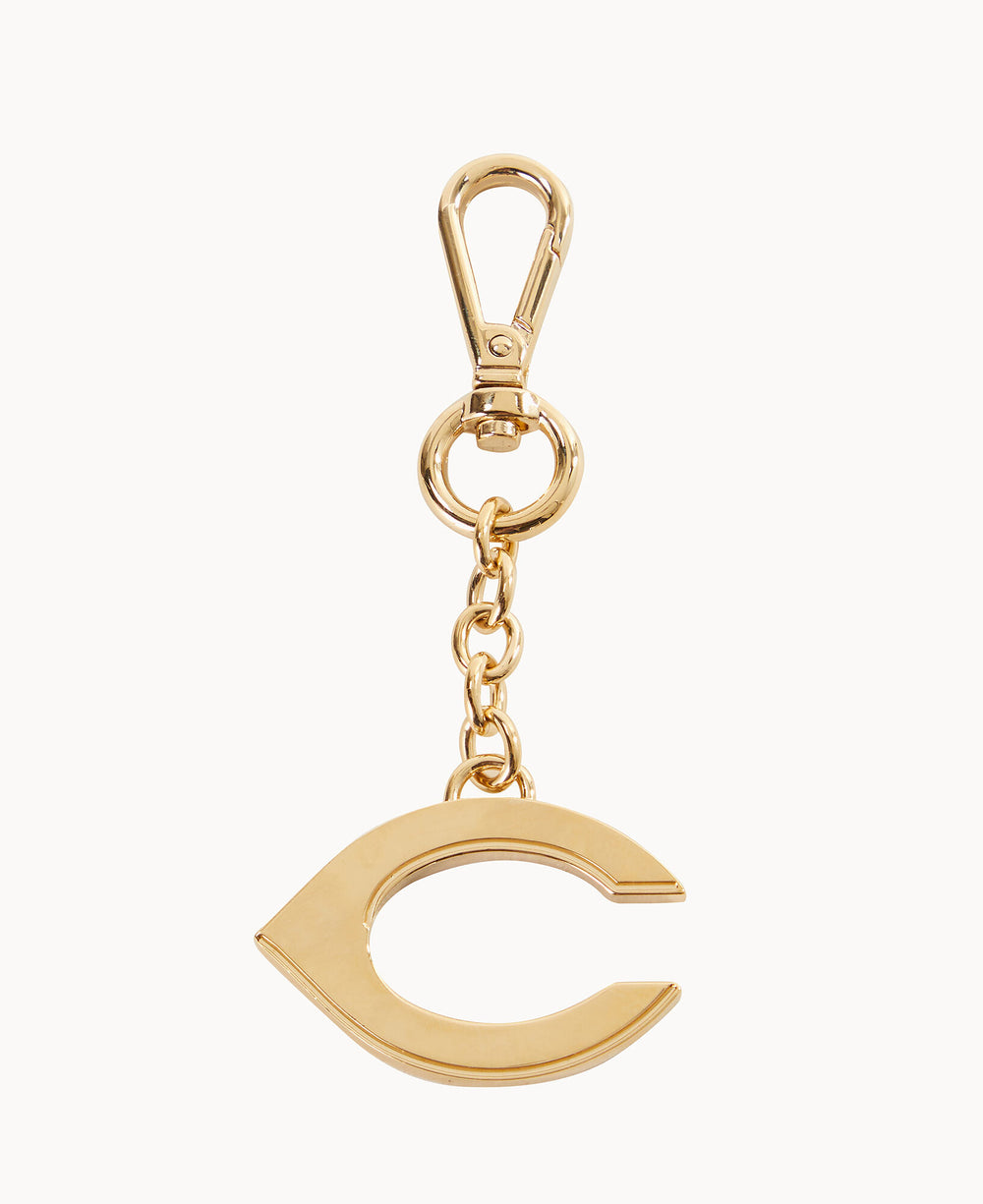 A gold keychain featuring a large, polished letter C charm attached to a clasp with a small chain. The background is plain white.
