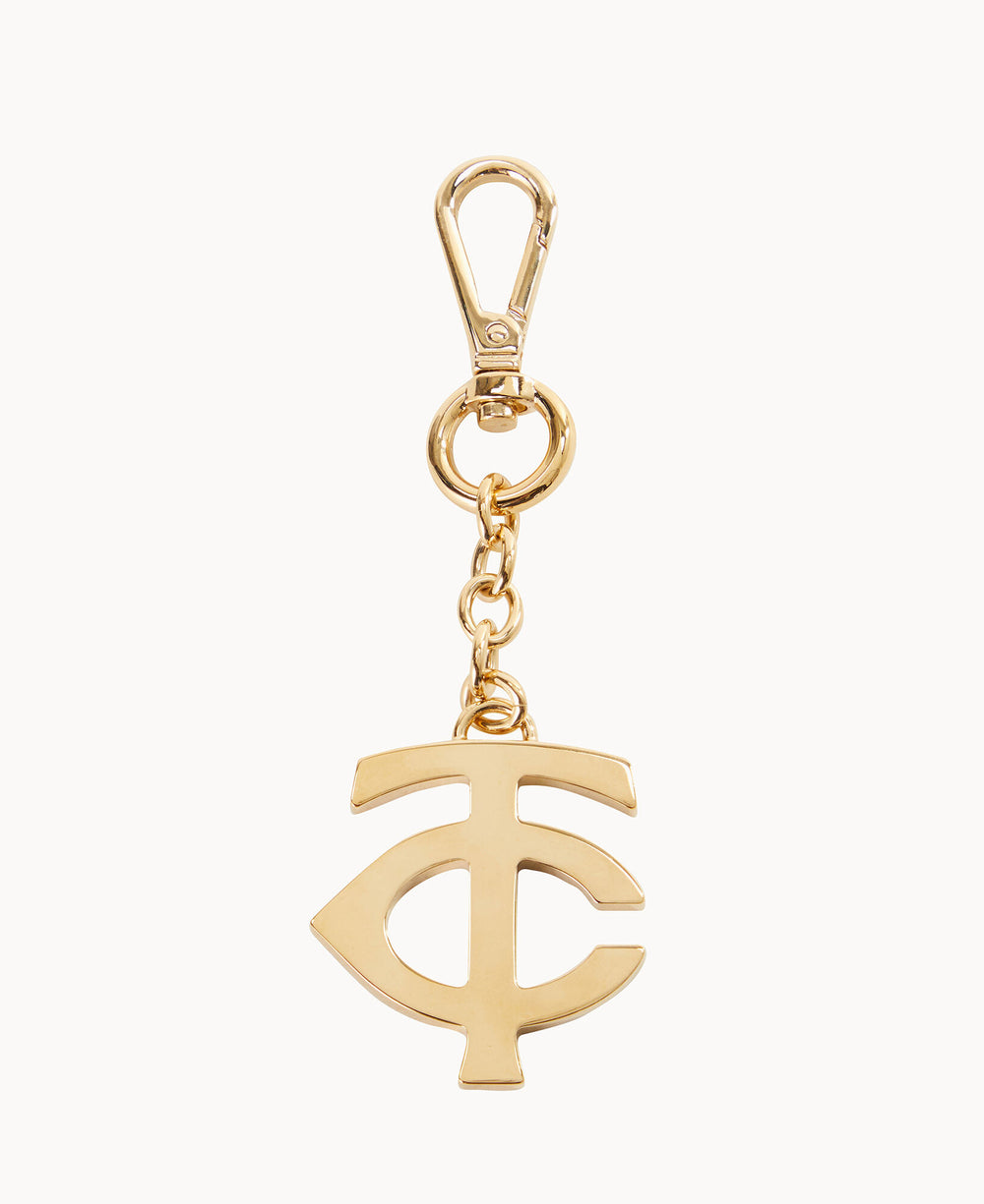 Gold keychain with a lobster clasp, featuring a hanging charm in the shape of a stylized interlocking C and F monogram. The design is minimalist and metallic, set against a white background.