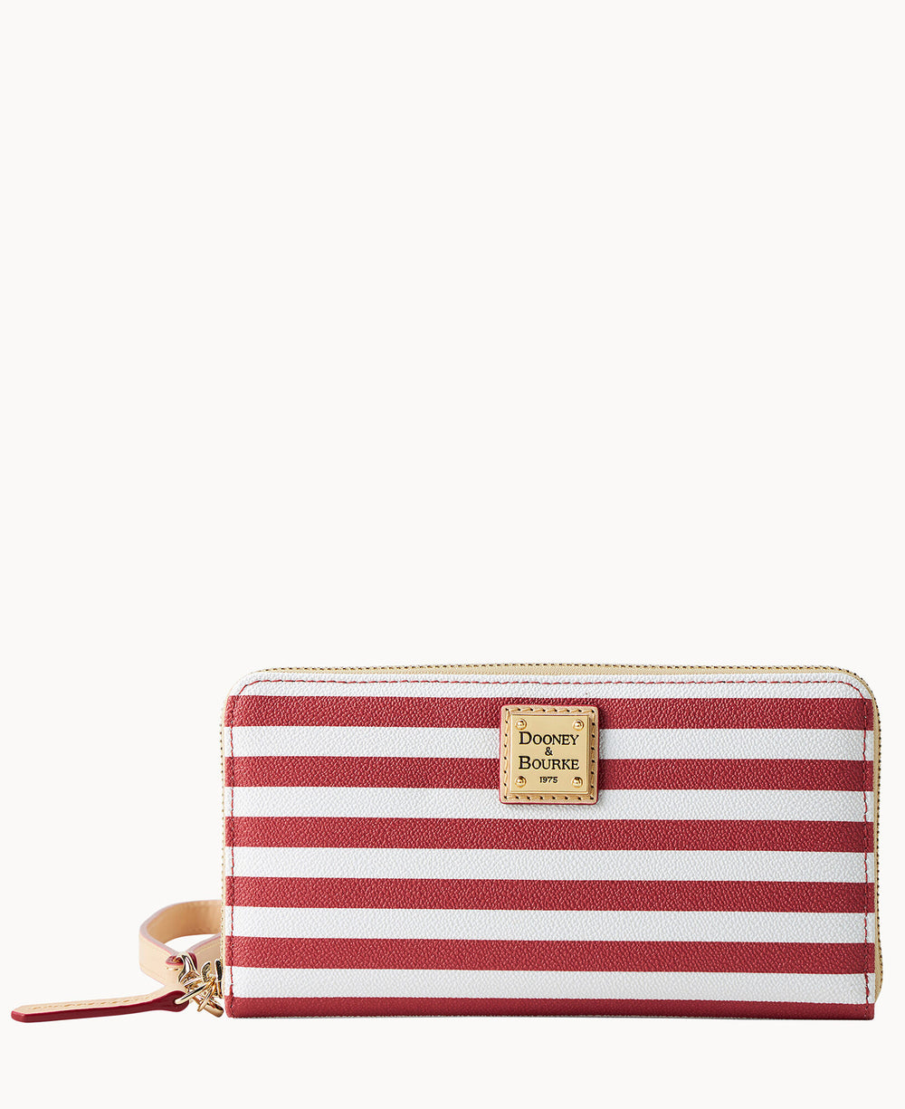 A zip-around wallet with red and white horizontal stripes, a tan wrist strap, and a gold square Dooney & Bourke logo plate on the front.