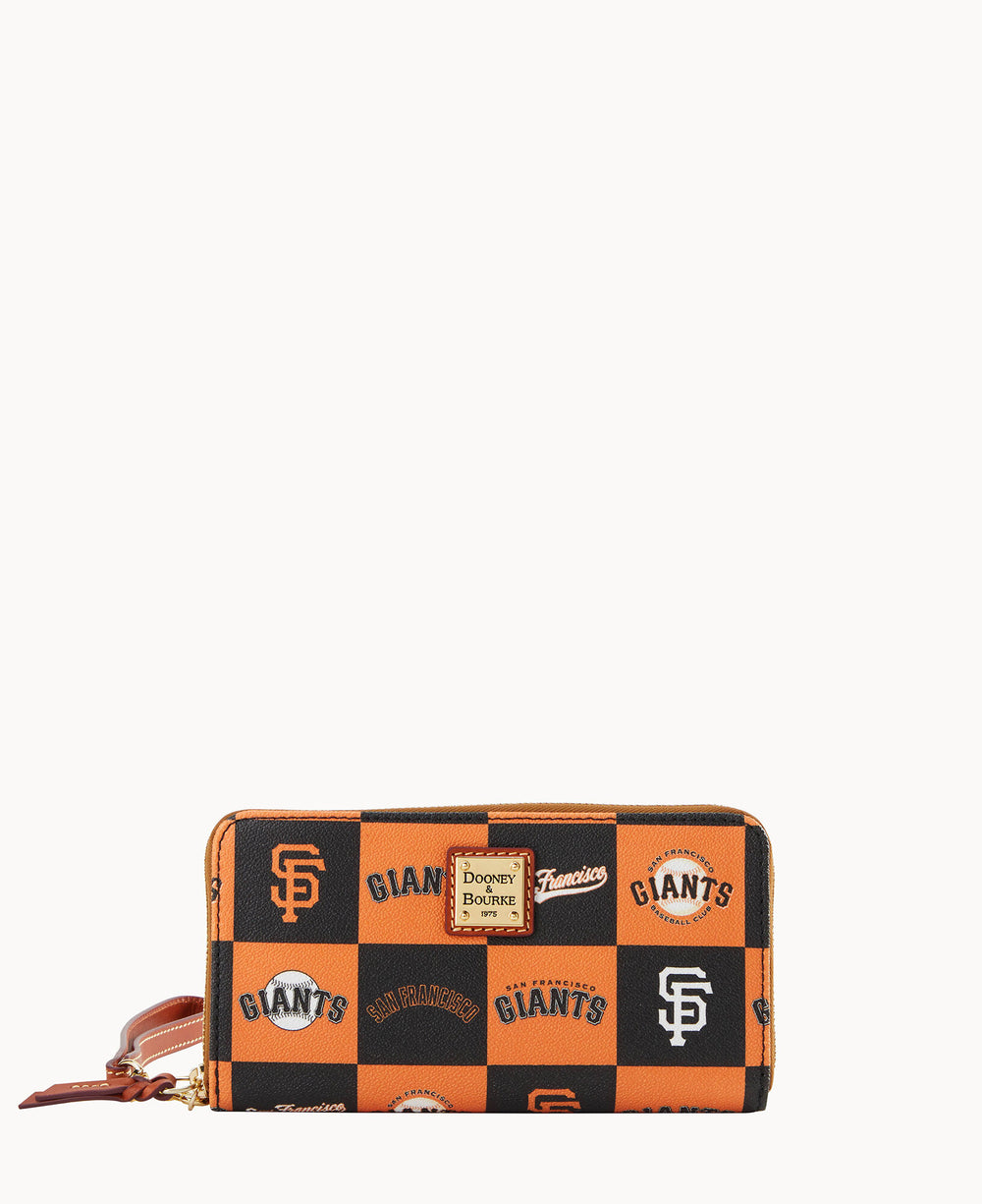 A rectangular wallet with an orange and black checkerboard pattern featuring San Francisco Giants logos, Giants text, and a Dooney & Bourke label on the front.