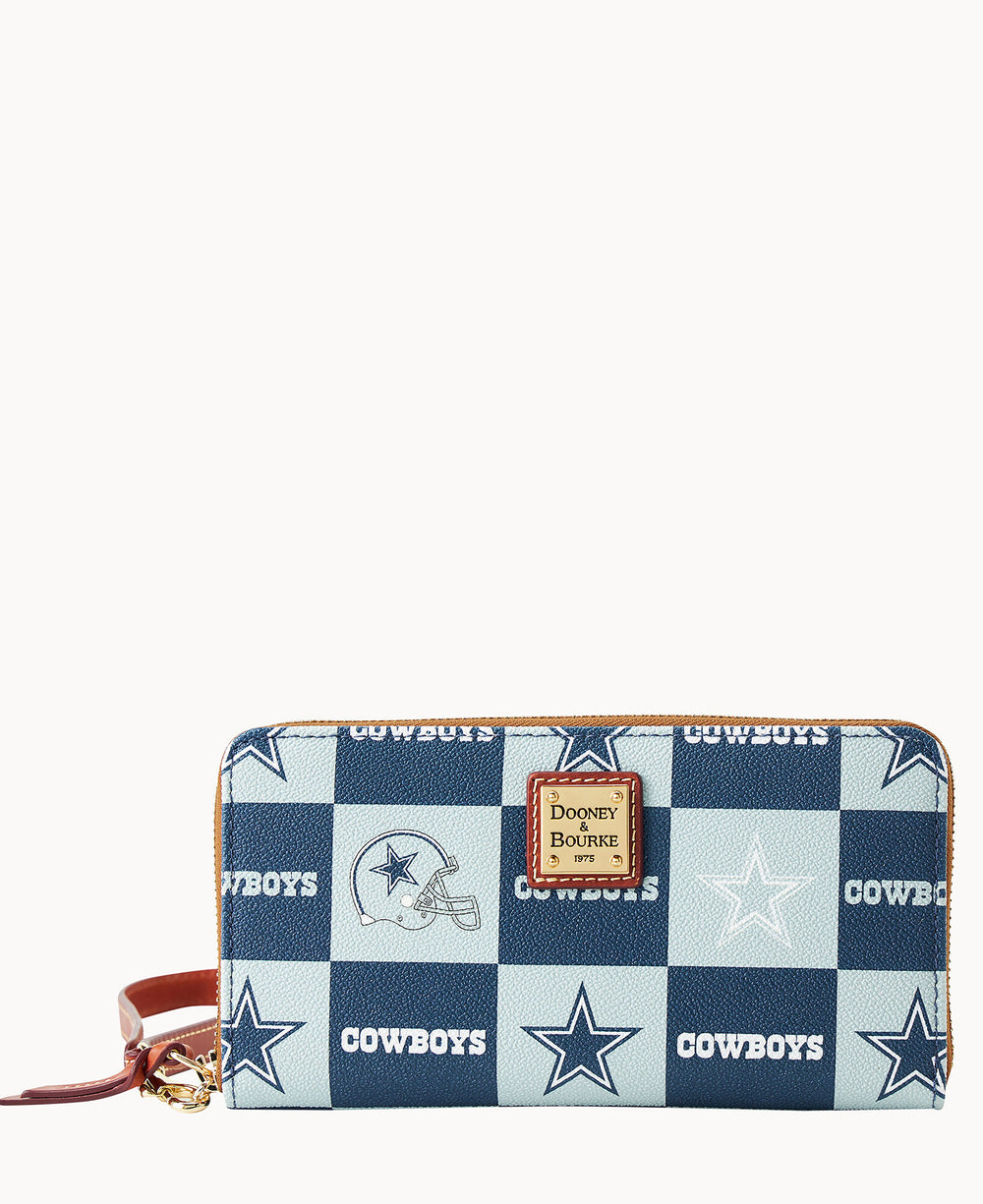 A rectangular wallet with a blue and white checkerboard pattern, featuring Cowboys text, stars, and helmet graphics. The wallet has a brown leather wrist strap and a Dooney & Bourke logo patch in the center.