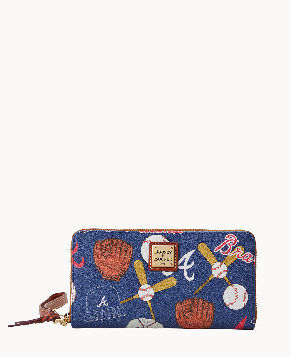 A blue zippered wallet with a brown leather strap, featuring a baseball-themed pattern with gloves, bats, balls, and A and Braves logos. The Dooney & Bourke label is displayed on the front.