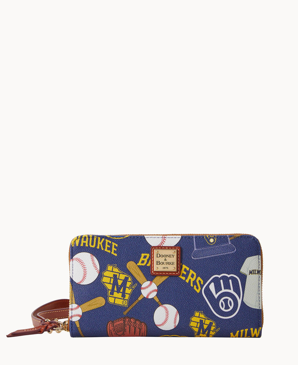 A zippered wristlet wallet with a Milwaukee Brewers baseball theme, featuring baseballs, gloves, bats, jerseys, and team logos in yellow, blue, and white. The wallet has a brown leather strap and gold Dooney & Bourke label.