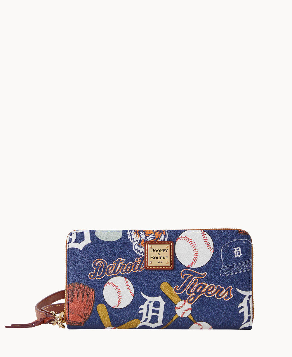 A navy blue wallet with Detroit Tigers-themed prints, including baseballs, bats, gloves, the team logo, and Detroit Tigers text. The wallet has a brown wrist strap and a gold zipper.